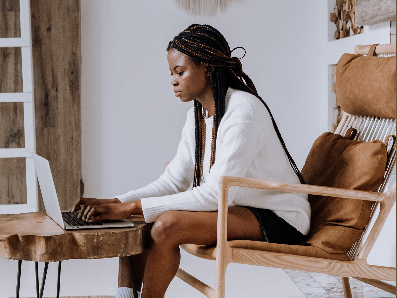 Kinsey Investigations - Can Adults be Cyberbullied - A seated woman works at a laptop on a coffee table.