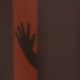 Kinsey Investigations Missing Person Cases - A shadow of a hand is cast on a wall.