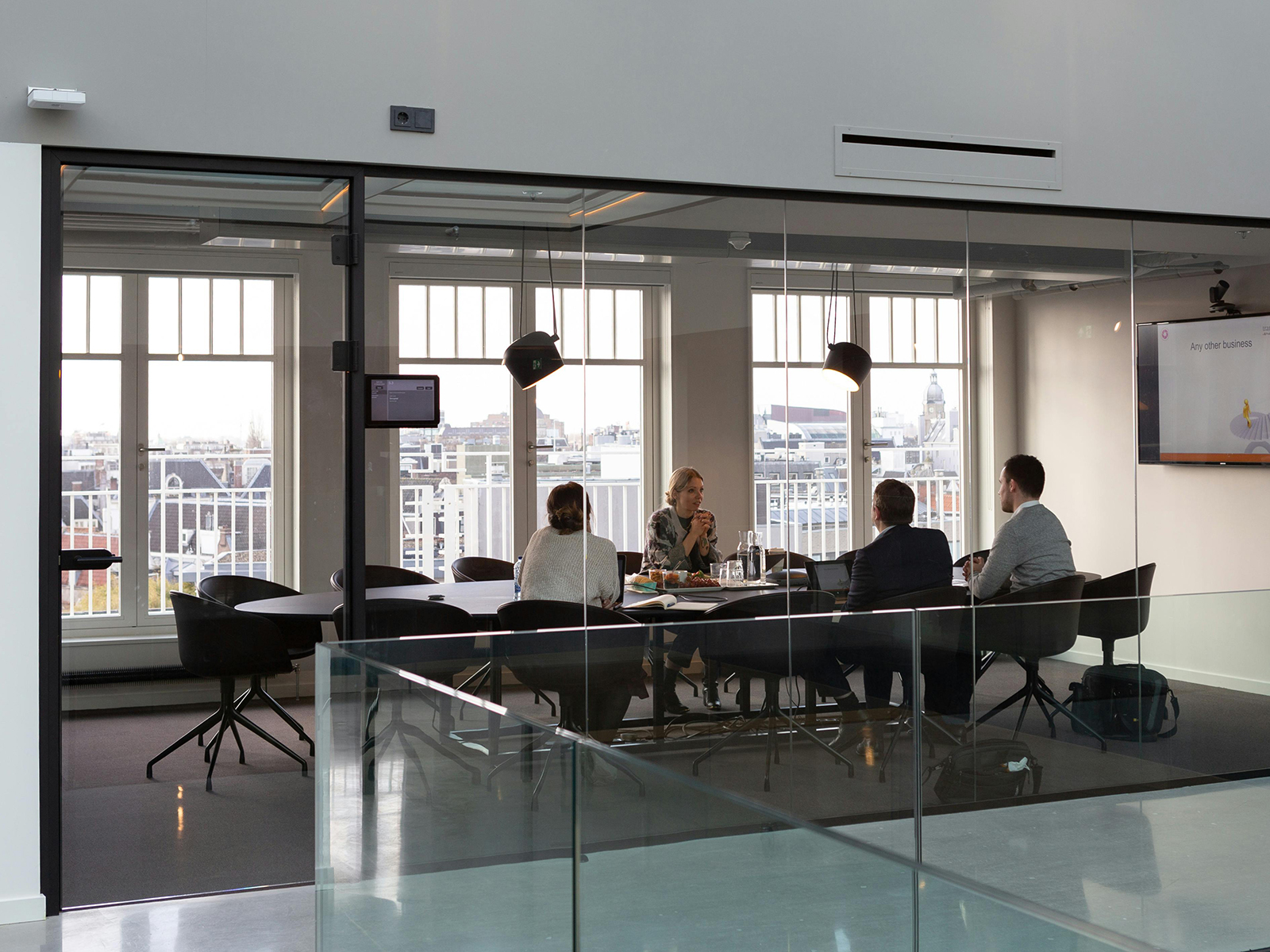 Kinsey Investigations Corporate Investigator - Business people sit around a conference table.