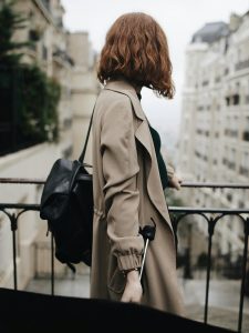 Kinsey Investigations Day in the Life of a PI - A woman holding a brief case looks down a city street.