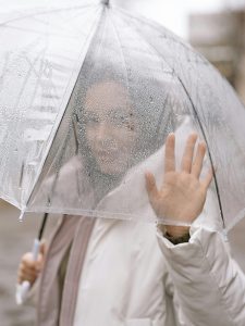 KinseyInvestigations.com Skip Tracing - A woman's face can be seen through a translucent umbrella