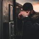 Kinsey Investigations Hire an Investigator to Find Someone - A man using a payphone conceals his face with his hand.