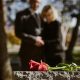 KinseyInvestigations.com Wrongful Death Investigations - A man and woman hold hands while looking at a grave stone.