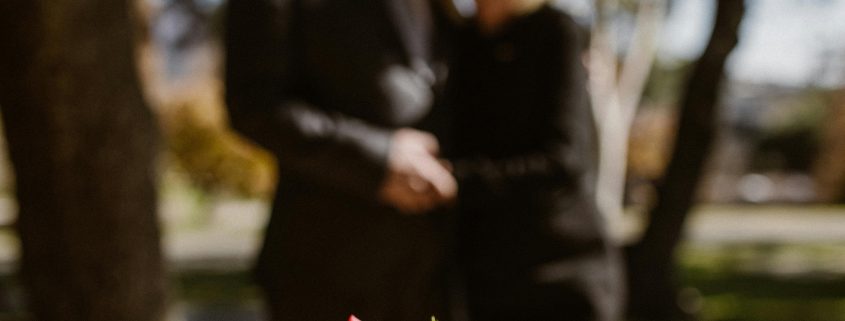 KinseyInvestigations.com Wrongful Death Investigations - A man and woman hold hands while looking at a grave stone.