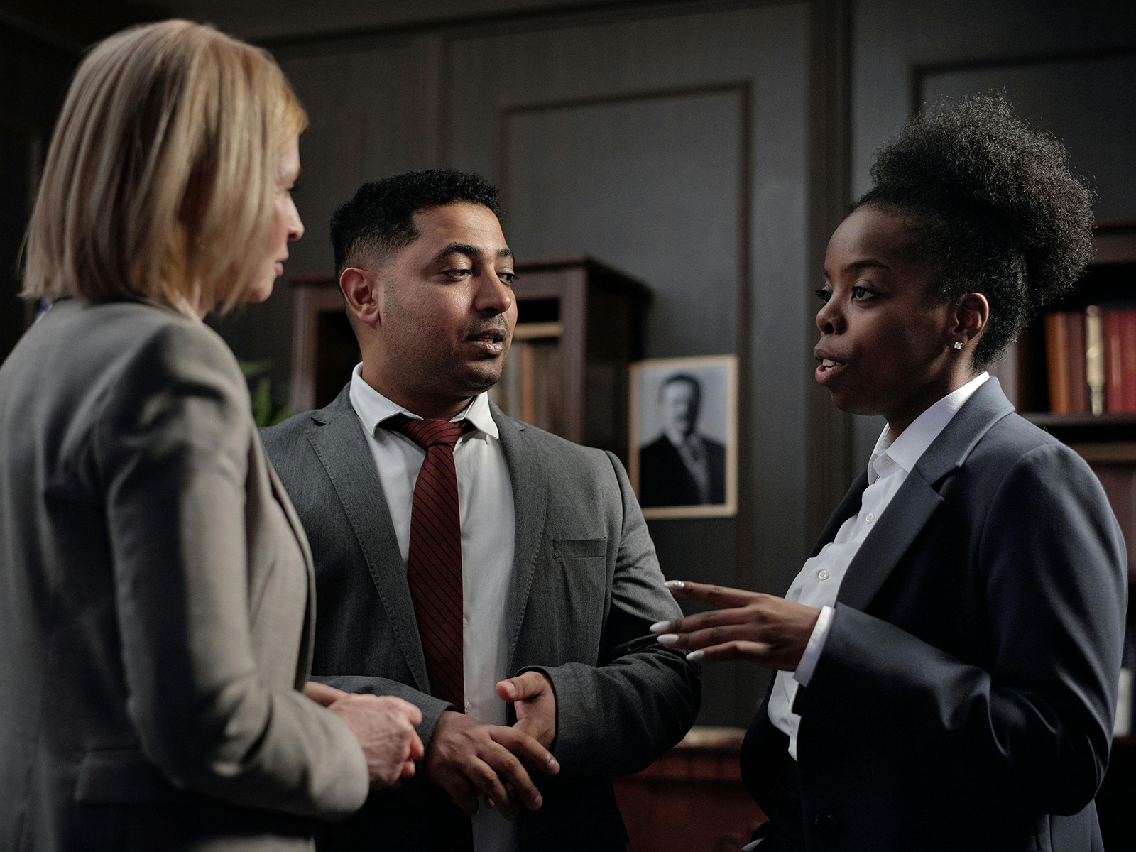 KinseyInvestigations.com Civil Litigation Support - Three professionals appear engaged in conversation.