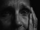 KinseyInvestigations.com Elder Abuse - An elderly person holds their palm to the side of their face.