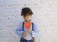 KinseyInvestigations.com Child Custody - A young boy holds a paper heart in front of his chest.