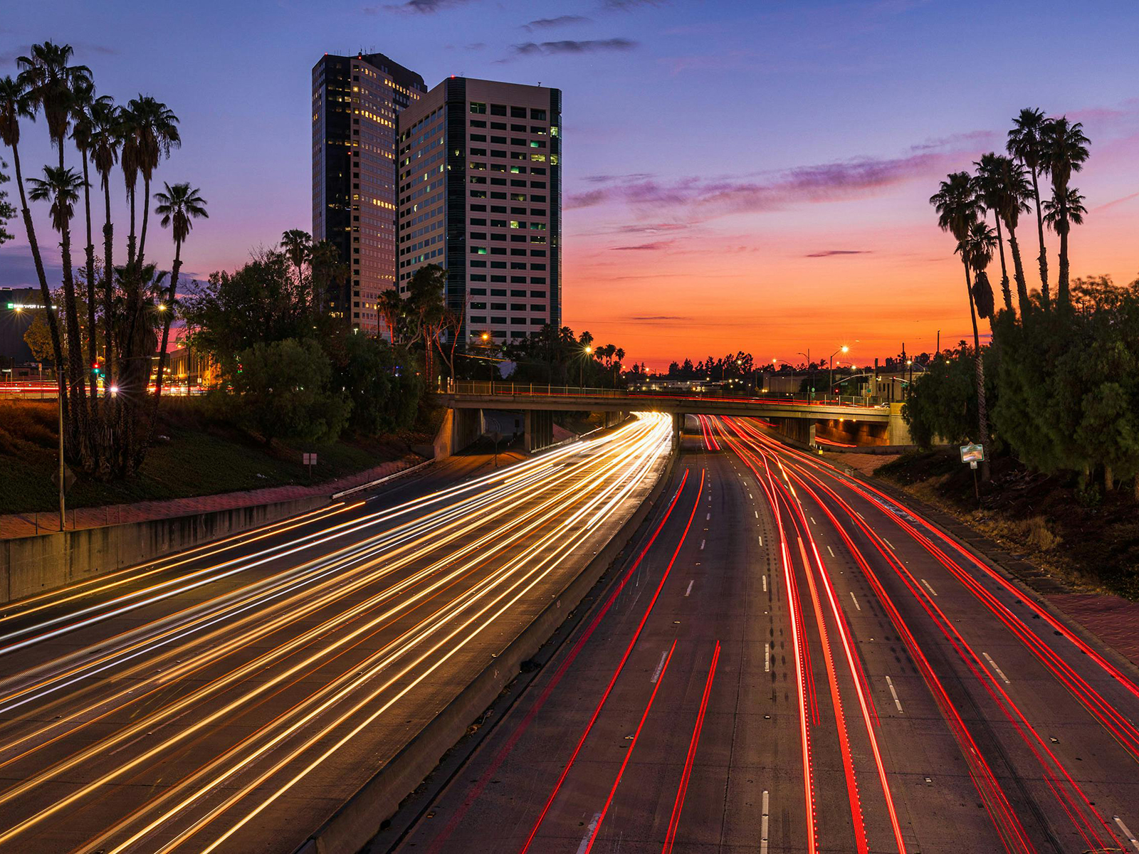 KinseyInvestigations.com Burbank Private Detective - A time-lapse image shows lights from moving traffic against a sunset.