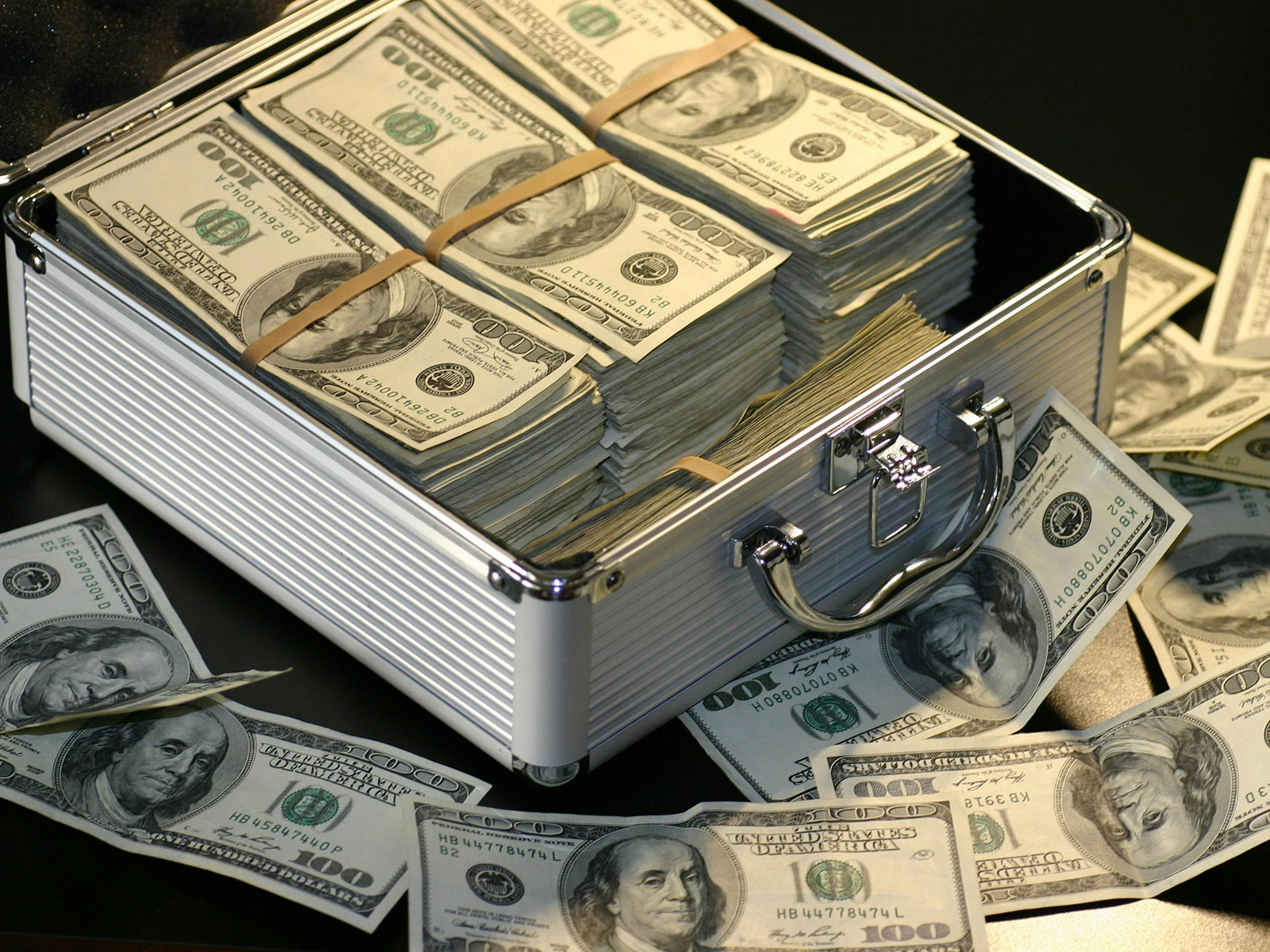 KinseyInvestigations.com Hidden Assets Investigations - A large sum of cash sits inside an open metal case.