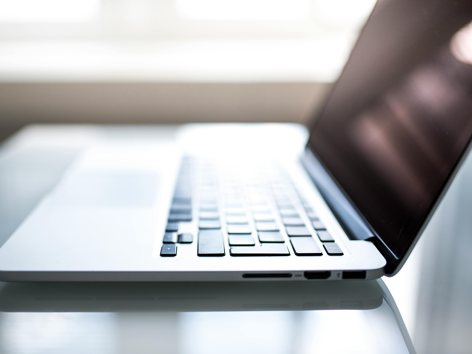 KinseyInvestigations.com Computer Forensics - A laptop computer sits on a table.