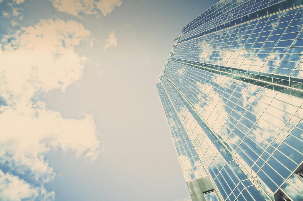 Tall skyscraper on a bright, sunny day - Consult Kinsey Investigations.