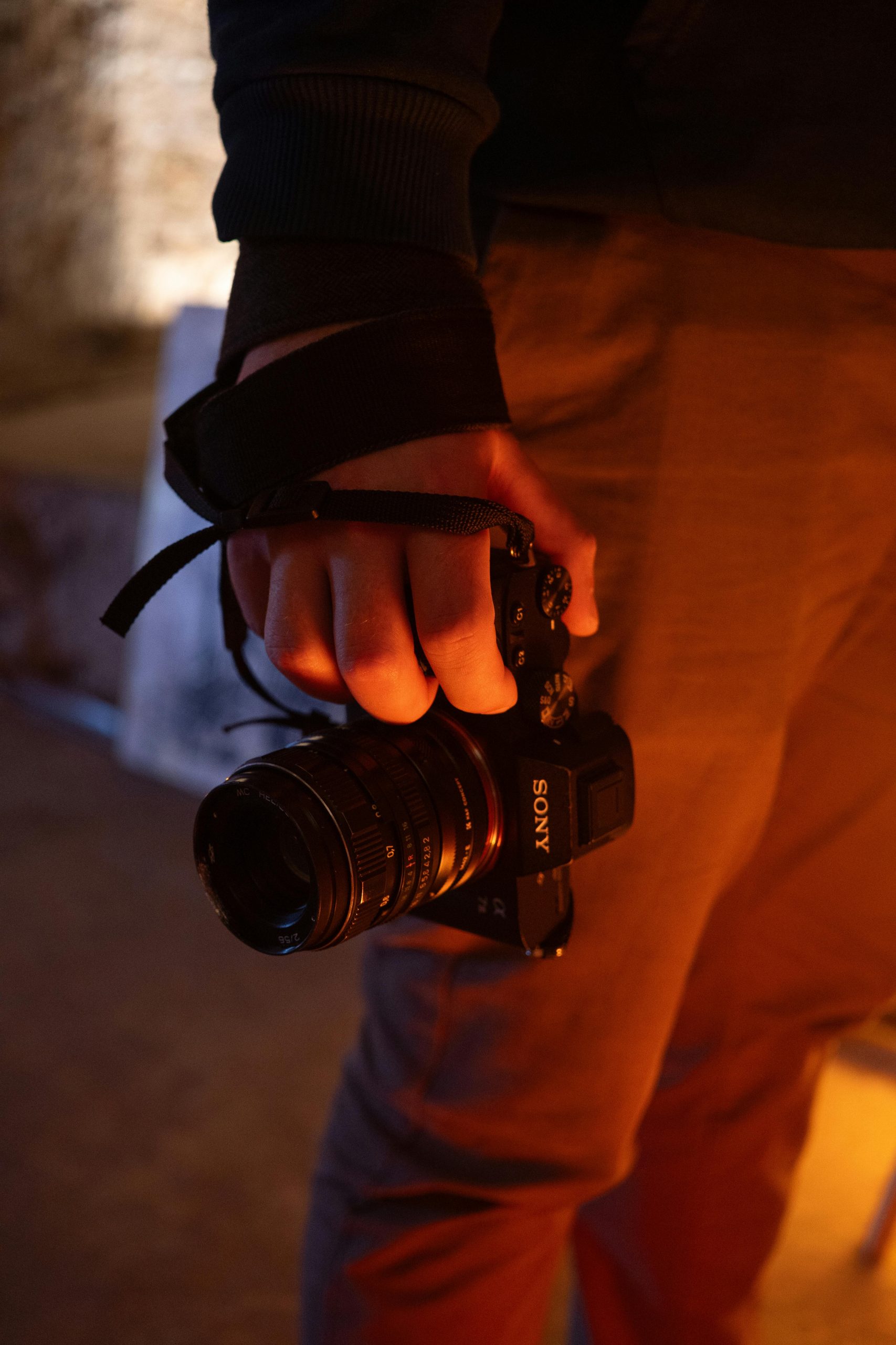 A camera in an investigator's hand at their side - Consult KinseyInvestigations.com.