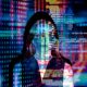 Woman standing in front of colorful projection of computer coding - Consult Kinsey Investigations.