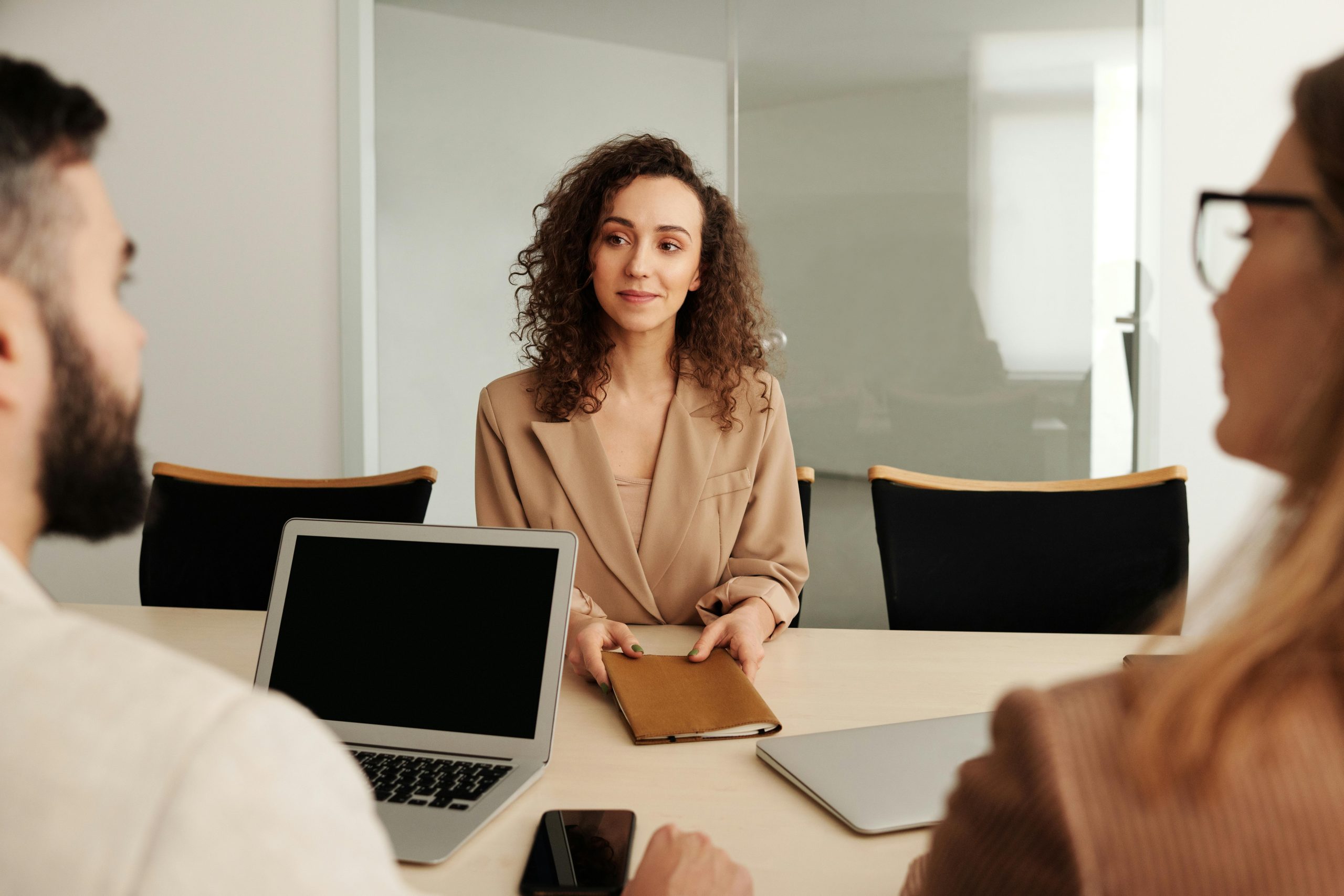 Woman with curly hair at a job interview - Contact KinseyInvestigations.com.