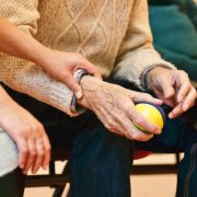 A couple with an elderly person sitting between them seen from below the shoulders - Contact Kinsey Investigations.