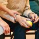 A couple with an elderly person sitting between them seen from below the shoulders - Contact Kinsey Investigations.