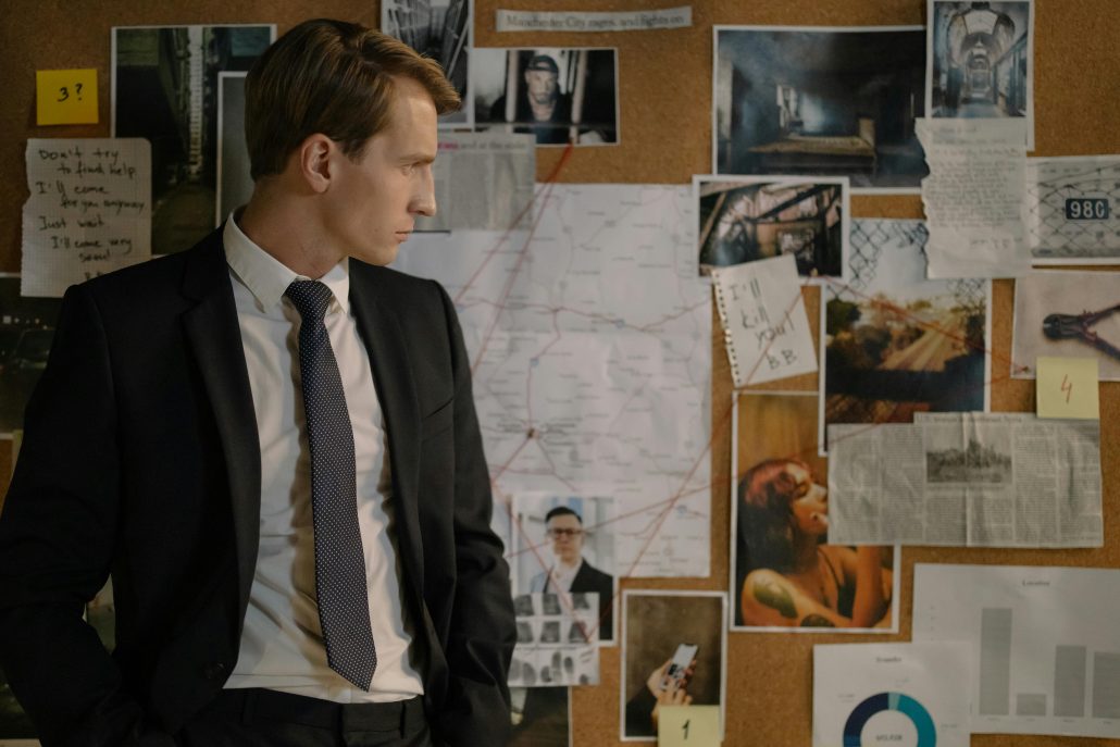 Investigator in front of evidence board - Consult Kinsey Investigations. 