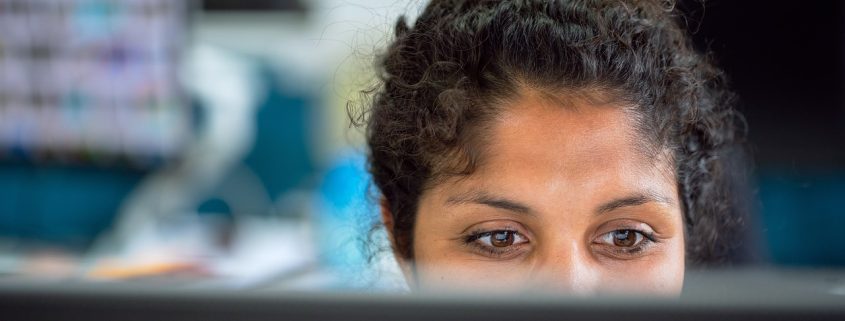 Female investigator at computer - Contact Kinsey Investigations.