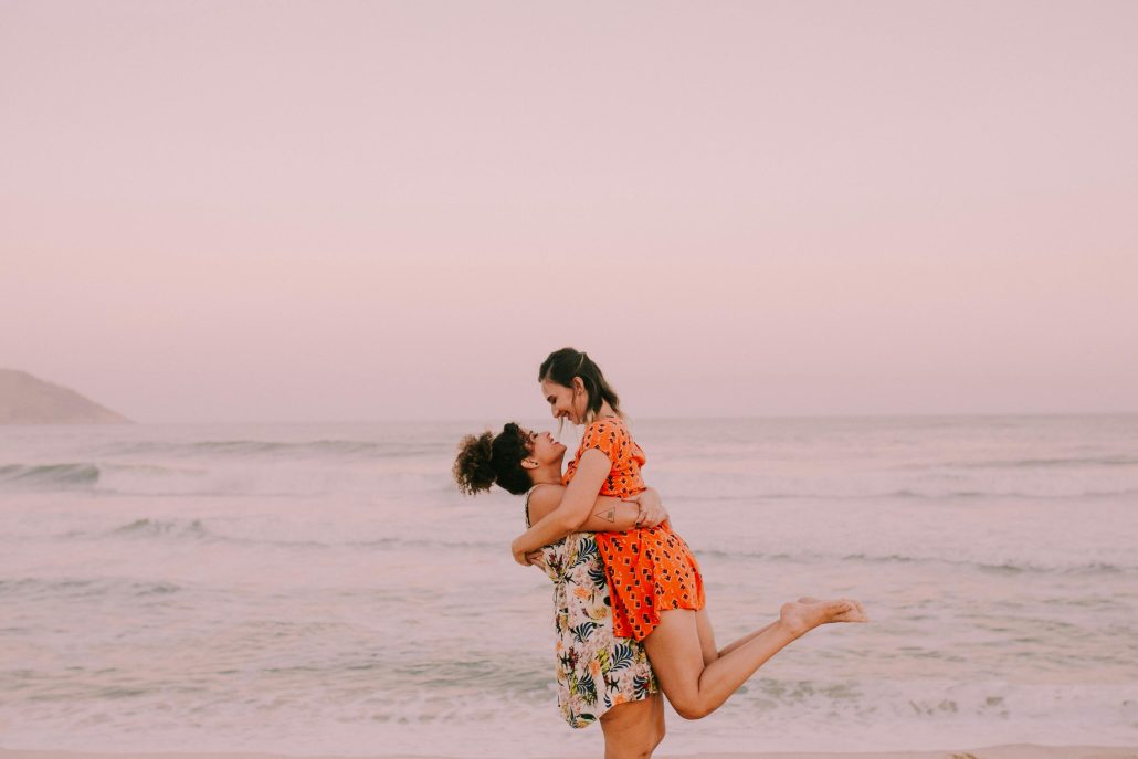 Couple embracing on the seashore - Contact Kinsey Investigations. 