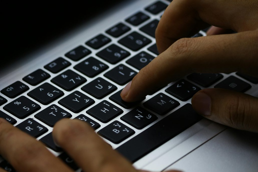 Hands on a keyboard - Consult Kinsey Investigations. 