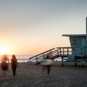 A lifeguard tower and people on the shore at Long Beach - Contact Kinsey Investigations.
