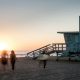 A lifeguard tower and people on the shore at Long Beach - Contact Kinsey Investigations.