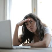 Woman seeking private investigator at computer - Contact Kinsey Investigations.