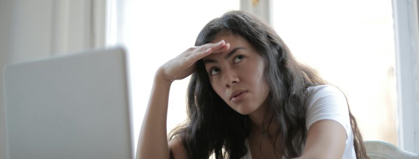 Woman seeking private investigator at computer - Contact Kinsey Investigations.